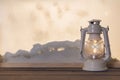 gas lantern wooden board near heap snow through window. High quality photo