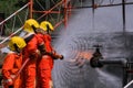 Gas leak from pipe and valv flame from gas leak.fire fighting with extingguishers and fire hose.fighters in action at gas Fire Royalty Free Stock Photo