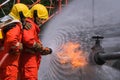 Gas leak from pipe and valv.flame from gas leak fire fighting with extingguishers and fire hose.fighters in action at gas Fire Royalty Free Stock Photo