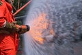 Gas leak from pipe and valv flame from gas leak.fire fighting with extingguishers and fire hose.fighters in action at gas Fire Royalty Free Stock Photo