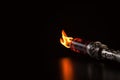 Gas lighter with flame on black background, closeup. Space for text, Fire torch on a dark background, AI Generated