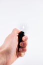 Gas lighter in hand burns fire on a white background Royalty Free Stock Photo