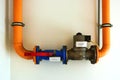 gas main line shut-off valve closeup view. red lever on blue lock. yellow painted steel pipes. Royalty Free Stock Photo