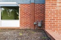 A gas meter on an exterior brick wall of a building in Grants Pass, Oregon, USA - October 30, 2022