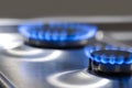 Gas Oven Concepts. Macro Shoot of Two Gas Burners on Stove Surface with Flames Royalty Free Stock Photo