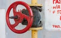 Gas pipe cog on a white wall background Royalty Free Stock Photo