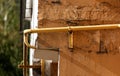 Gas pipe hanging on the wall of a building Royalty Free Stock Photo