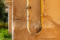 Gas pipe hanging on the wall of a building Royalty Free Stock Photo