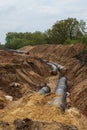 Gas pipeline under construction. Black pipes buried in the ground