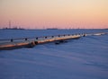 Gas pipelines, crane and pipes for gas and oil transportation, gas processing plant, against the backdrop of sunset Royalty Free Stock Photo