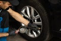 Gas pumping of a car wheel. Car tire inflation. Car tire pressure check using air pressure guage. Mechanic inflating a Royalty Free Stock Photo