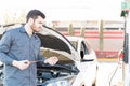 Gas Station Attendant Checking Engine Oil