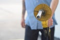 Gas station attendant holding a hose