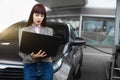 Gas station, business and people concept. Young pretty business woman on petrol station, while filling her car Royalty Free Stock Photo