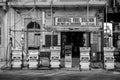 Gas station featuring a variety of pumps and vintage-style posters advertising fuel products.