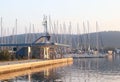 Gas station in the Mediterranean marina on the background of sailing yachts in the rays of sunset. Refueling boats and fishing Royalty Free Stock Photo