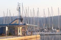 Gas station in the Mediterranean marina on the background of sailing yachts in the rays of sunset. Refueling boats and fishing Royalty Free Stock Photo