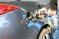 Gas station. Pump fuel petrol in tank car. Gasoline oil in nozzle. Close-up of the hand and the fuel gun. Blurred Royalty Free Stock Photo