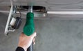 Gas station worker filling up bronze pickup truck tank Top View. Closeup hand holding green gas pump nozzle Royalty Free Stock Photo