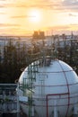 Gas storage sphere tank in oil refinery plant at sunrise