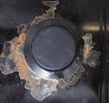 A gas stove burner dirty with scale and carbon deposits. Cleaning a gas stove with a cleaning agent. Cleaning service