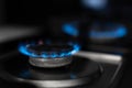 Gas stove, gas is burning. Gas burner on a dark background