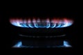 Gas stove burning in the kitchen, blue flames black background Royalty Free Stock Photo