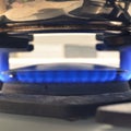 Gas stove burning in the kitchen, blue flames black background Royalty Free Stock Photo