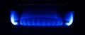 Gas stove burning in the kitchen, blue flames black background Royalty Free Stock Photo