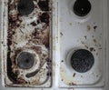 Gas stove in the mud. four gas burners are smeared. dirt on the stove. Dirty stove in the kitchen. Royalty Free Stock Photo