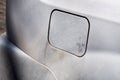 Gas tank cover gray dirty car. Royalty Free Stock Photo