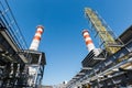 Gas turbine power plant on natural gas with chimneys of red-white color against a blue sky on a sunny day Royalty Free Stock Photo