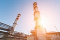 Gas turbine power plant on natural gas with chimneys of red-white color against a blue sky on a sunny day Royalty Free Stock Photo