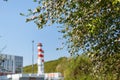 Gas turbine power plant on natural gas with chimneys of red-white color against the blue sky in the apple orchard Royalty Free Stock Photo