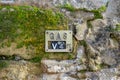 Gas valve and location sign seen attached to an old stone wall. Royalty Free Stock Photo