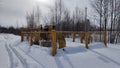 Gas valves with snow in winter frost. Gas line valves behind the metal fence Royalty Free Stock Photo