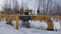 Gas valves with snow in winter frost. Gas line valves behind the metal fence Royalty Free Stock Photo