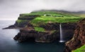 Gasadalur village and Beautiful waterfall with dark clouds, Vagar, Faroe Islands, Denmark