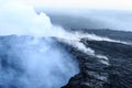 Gases and steam rise from the Kilauea Caldera at dawn