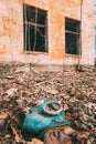 Gasmask Near Abandoned Ruined Old Village School Building In Chernobyl Resettlement Zone. Belarus. Chornobyl Catastrophe