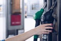 Gasoline and diesel distributor at the gas station. The woman is going to refuel the car. Royalty Free Stock Photo