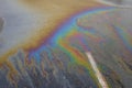 Gasoline flows on the asphalt surface in a car park. Royalty Free Stock Photo