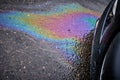 Gasoline and oil spill on wet asphalt in a parking lot near a hypermarket Royalty Free Stock Photo