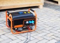 Gasoline Portable Generator on the House Construction Site. Close up on Mobile Backup Generator. Standby Generator Royalty Free Stock Photo