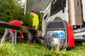 Gasoline Powered Generator Running Next to Camper Van RV