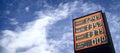 Gasoline price dispay benath a dramatic sky. Royalty Free Stock Photo