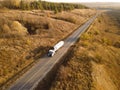 Gasoline truck Oil trailer, truck on highway driving along the road. Tank truck at work aerial view above