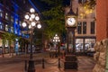 Gastown Steam Clock and Vancouver downtown beautiful street view at night. Royalty Free Stock Photo