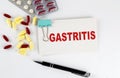 GASTRITIS text written in a card with pills. Medical concept