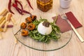 gastronomic composition of burrata cheese plate with grilled cherry tomatoes on a bed of arugula with fork Royalty Free Stock Photo